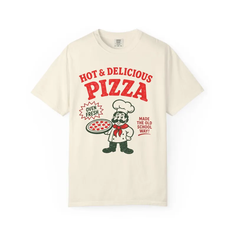 A cream t-shirt reading Hot & Delicious Pizza, with a pizza chef holding a pie